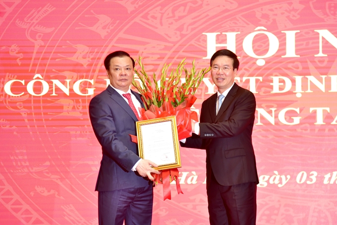 El miembro permanente del Secretariado del PCV, Vo Van Thuong (i.) felicita al nuevo secretario del Comité del Partido de Hanói, Dinh Tien Dung.